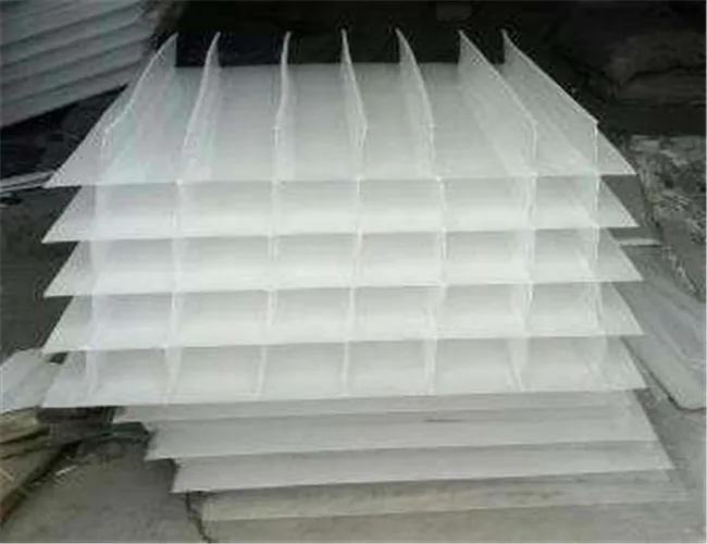 Stacked white inclined plate packs used as the settling media inside a clarifier
